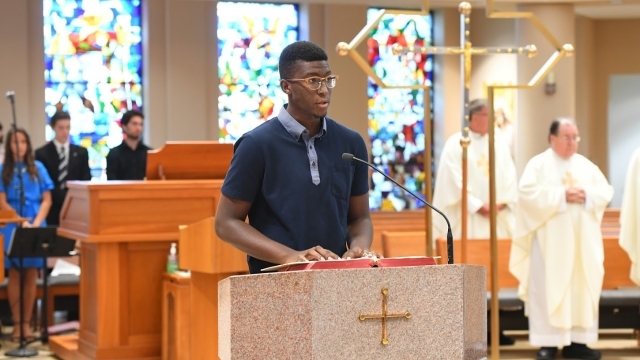 Student standing at podium in church