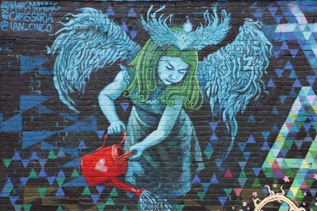 Mural of female angel holding watering can