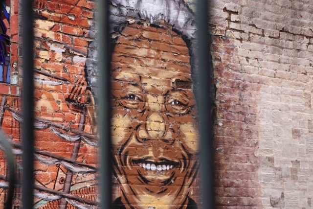 Mural of male on brick wall