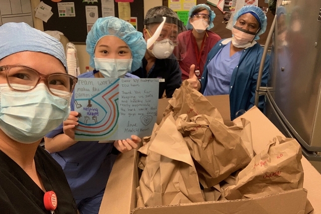 Healthcare workers posing with food donated