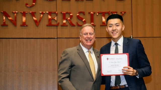 Andrew Kwong  on stage with Dean DiGate to receive award