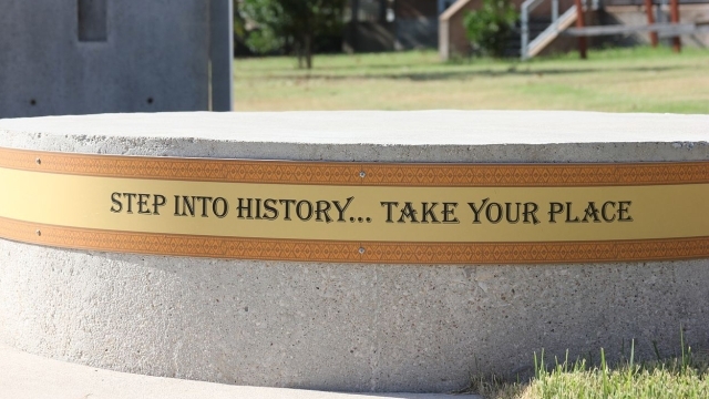 A round piece cement with the following words wrapped around it "Step Into History...Take Your Place"