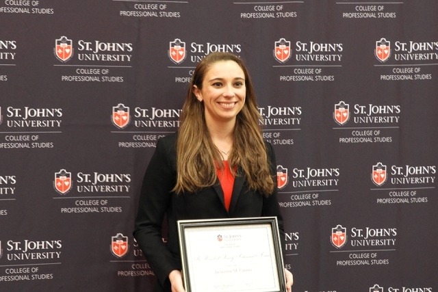 Jacqueline “Jackie” Canino in front of St. John's banner
