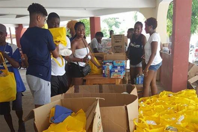 Students gathered packing up food to hand out in yellow bags