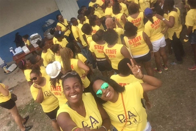 Staff gathered together wearing Project St. Anne shirts