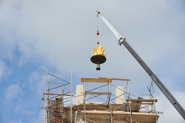 Crane placing DAC torch into tower