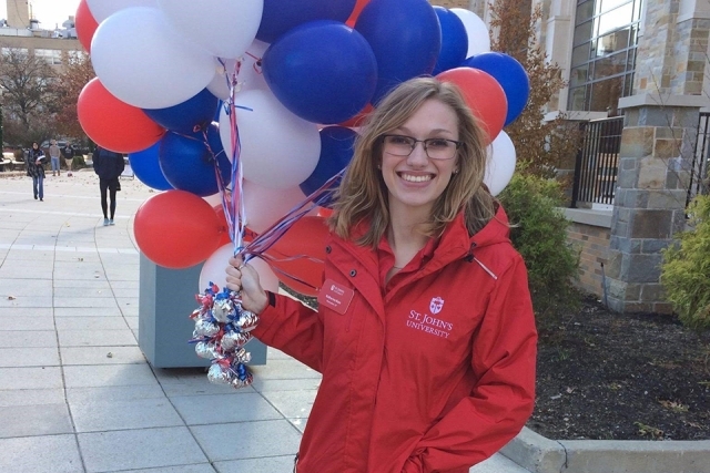 Katherine Ross holding red, white and blue balloons