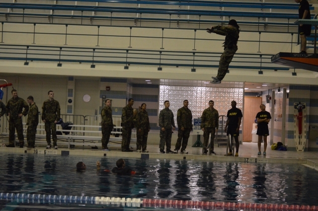 A cadet takes a confident step off of the 5 meter platform while blindfolded during the Combat Water Survival Assessment (CWSA). The CWSA is used to measure individuals swimming ability. (circa Fall 2019)