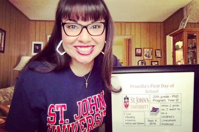 Priscilla Delgado with a sign on her Frist Day of School for her Ph.D. program in 2019