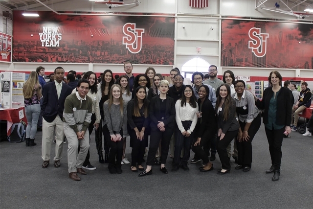 Group of Students and Faculty posing in Taffner Field House 