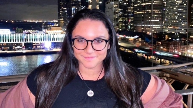 Kelsey Dimesa against New York skyline at night