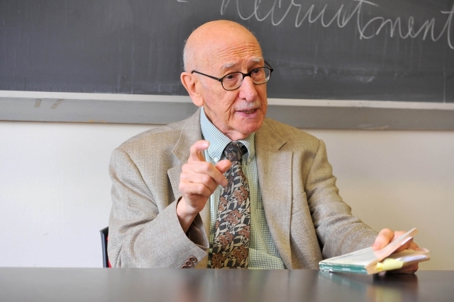 Jack Franzetti ’45UC, ’46G, ’56Ph.D. sitting at a desk speaking