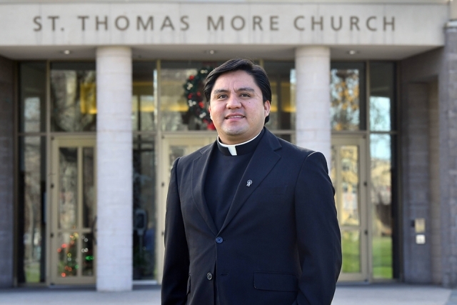 Fr. Luis Romero standing in front of St. Thomas More Church