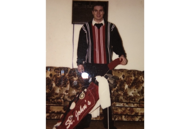 Alumni Mike O'Shea showing off his St. John's logo golf bag from 1995 as a member of the golf team  