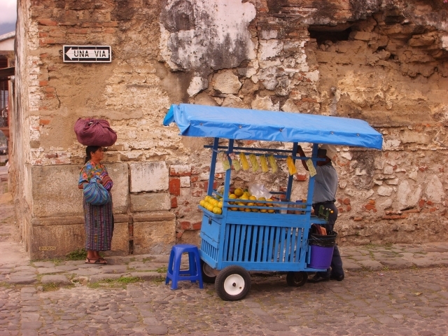 2 people near a blue food cart in Guatemala