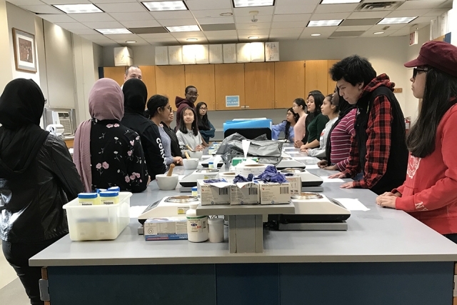 CFPP students gathered around a table in a lab classroom