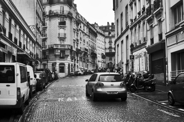 a black and white photo of a street in Paris