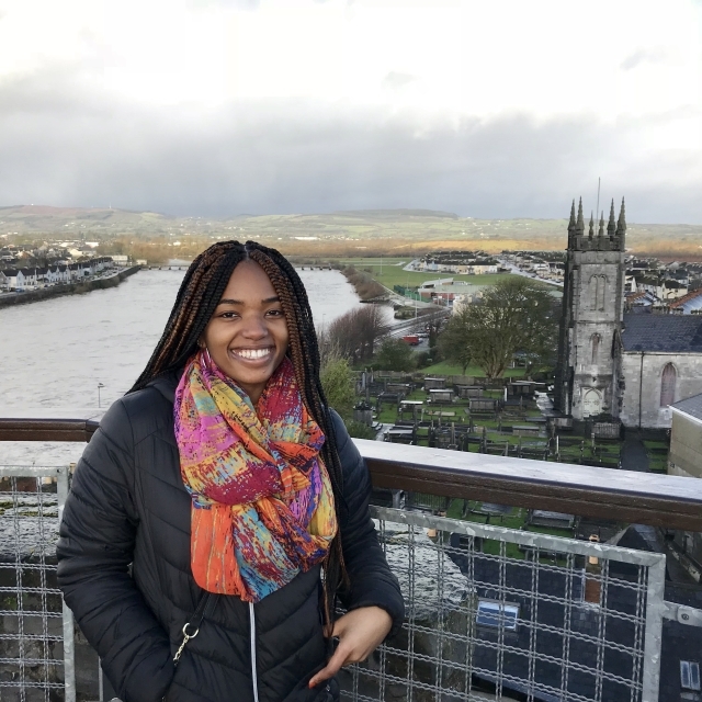 Student standing above the city with Limerick in the background