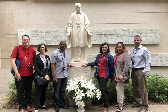 VMI members pose for a picture next to St. Vincent de Paul statue