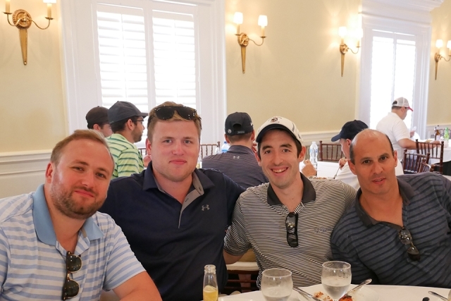 St. John's alumni and friends pose for a photo inside the golf clubhouse