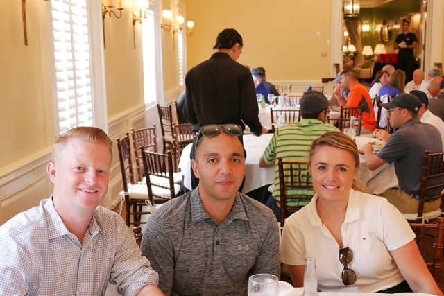 St. John's alumni and friends pose for a photo inside the golf clubhouse