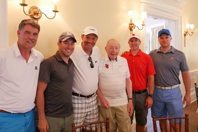 St. John's alumni and friends pose for a photo inside the golf clubhouse