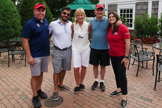 St. John's alumni and friends pose for a photo at the GAHW golf event