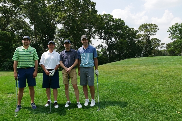 St. John's alumni and friends pose for a photo on the golf course