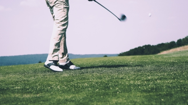 Golfer on a golf course view from the ground