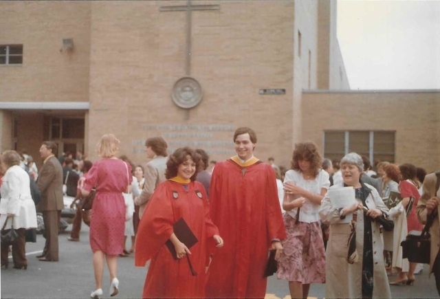 Photo of two alumni in academic atiire at 1983 commencement ceremony 