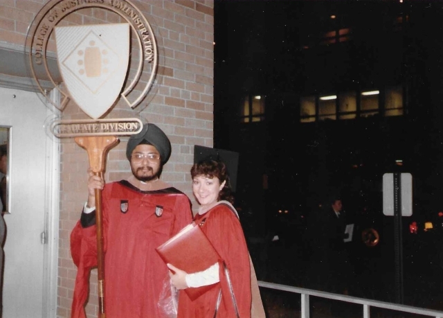 Two alumni Paul Ravinder Singh and Laura Bellacicco in academic attire at their graduate level commencement ceremony in 1985