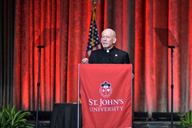 President Shanley speaking at podium on stage