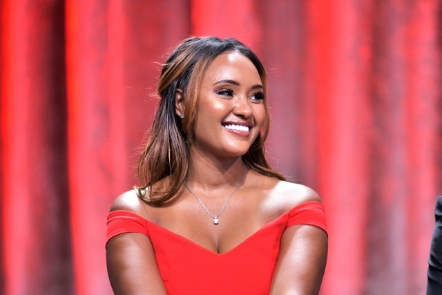Female sitting on stage smiling 