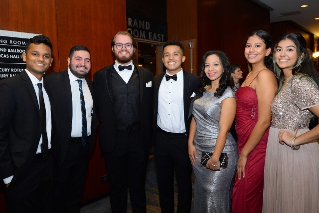 Group shot of alumni posing for photo dressed up