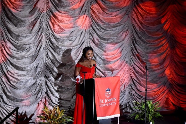 Female standing at podium on stage
