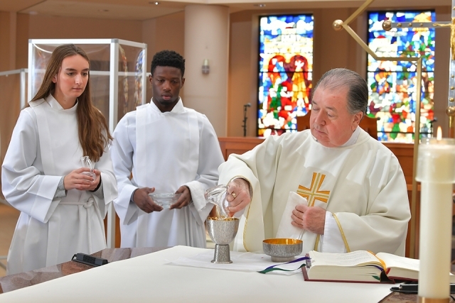 Sacristans and Fr. Holliday in St. Thomas More Church