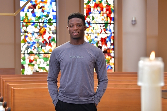 Raphael Civil standing in St. Thomas More Church