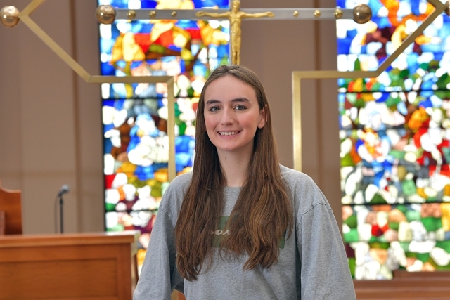 Hailey Pomara standing in St. Thomas More Church