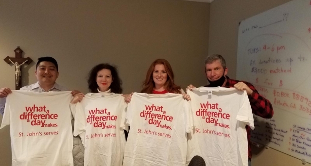 Four adults holding t-shirts saying What a Difference A Day Makes