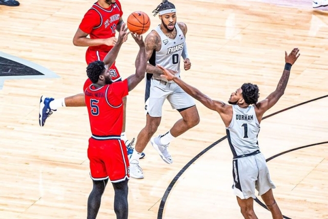St. John's Mens Basketball player taking a shot on the Providence court