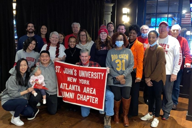 St. John's University Atlanta Chapter members holding a sign 