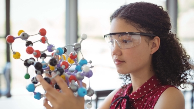 Girl wearing protective googles working with spatial object