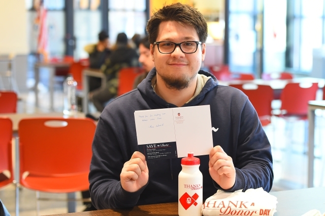 Thank A Donor Student holding card