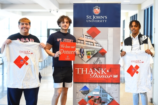 Thank A Donor Students Holding Shirt and Signs Thanking Donors