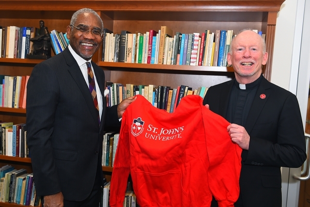 Rep. Greg Meeks Visits Queens Campus to meet with Fr. Shanley who gifts him a St. John's sweatshirt