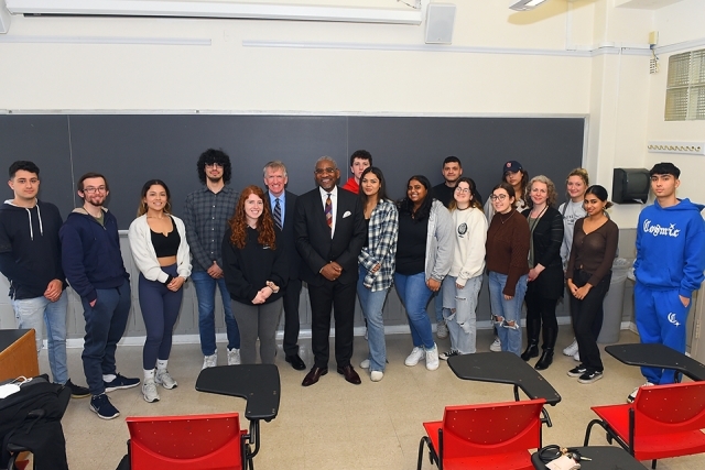 Students posing for photo with Rep. Greg Meeks
