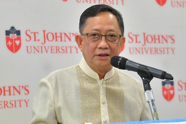 Rev. Pilario at the microphone