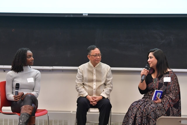 Three speakers sitting in chairs 