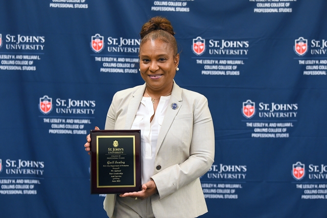 Gail Sealey holding a plaque award 
