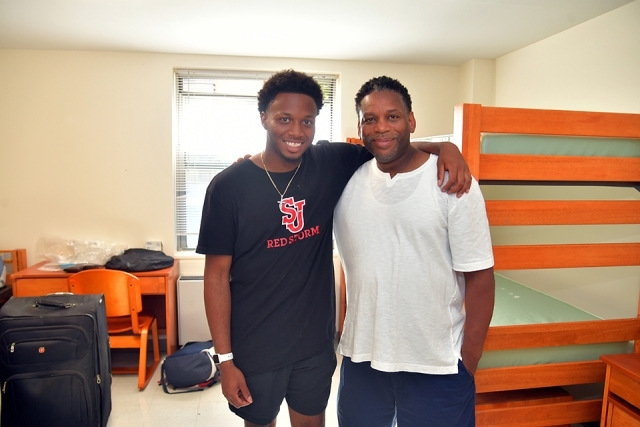 Student and family member inside dorm room